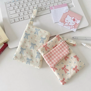 Floral nurse pocket protector with bow patterns shown next to a laptop and stationery