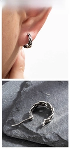 Macro detail of retro braided texture and antique silver finish on steel hoop earrings