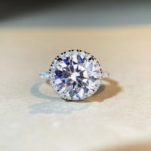 Detailed macro view of 1 carat moissanite ring with halo setting and micro-pave band