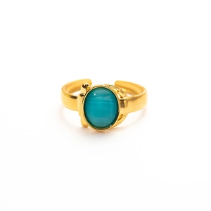 Detailed close-up of vintage gold titanium ring with oval green cat-eye gemstone