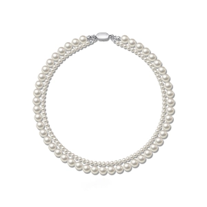 Detail of elegant double-layered white pearl necklace with silver oval metal clasp