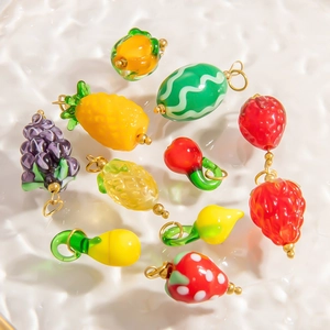 Colorful fruit glass pendants with gold hooks for DIY necklace making on white background