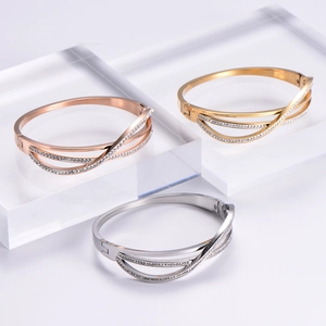 Elegant criss-cross rhinestone bracelets in rose gold, gold, and silver finishes