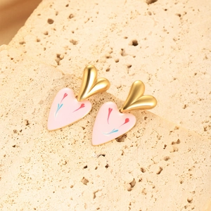 Detail of heart earrings with gold top and pink enamel floral drop on stone base