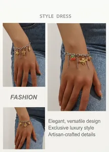 Detail of silver chain bracelet with assorted gold turtle and starfish charms on model
