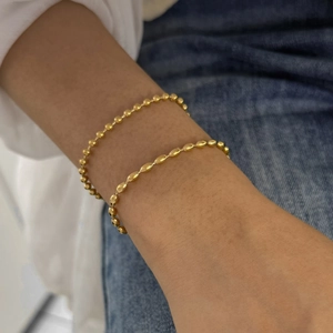 Elegant gold-tone stainless steel double-layer beaded bracelet set worn on a female wrist