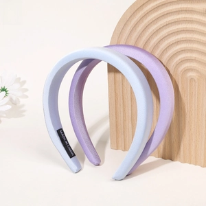 Close-up of thick satin headband set in light blue and lavender purple with fabric detail