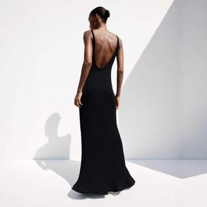 Detailed back view of a slim-fit backless knitted maxi dress with vertical ribbed texture