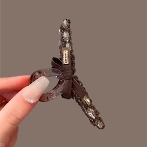 Elegante pinza per capelli con cristalli neri, strass e fiocco per acconciature di classe