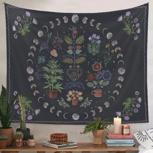 Detail of bohemian tapestry featuring botanical moon phase design hanging over a wooden side cabinet