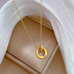 Detail of double ring gold necklace with pavé cubic zirconia on soft white tulle fabric