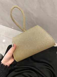 Elegant gold evening clutch bag with glitter finish and matching top handle for women