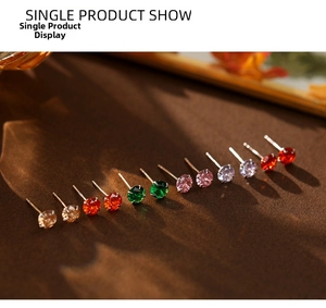 Close-up of six pairs of S999 silver stud earrings with colorful round cut gemstones