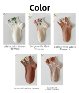 Close-up of five pairs of combed cotton socks featuring 3D floral embroidery and ribbing