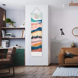 Scenic landscape tapestry with mountain and forest print hanging in a modern living room