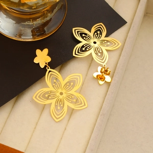 Macro shot of 18k gold plated stainless steel flower earrings with hollow petal design