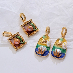 Detail of vintage enamel earrings with persimmon and pastoral bird motifs with pearls
