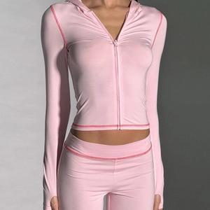 Detail of pink zip-up hooded jacket with matching leggings and stylish contrast stitching