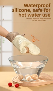 Waterproof silicone oven mitt lifting a boiled egg from hot water to show heat resistance