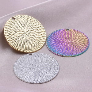 Detailed view of textured round 18k gold and silver pendants for DIY jewelry making