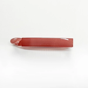Detailed view of large red jelly banana hair clip with glossy finish and minimalist design