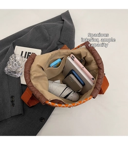 Top view of spacious interior in orange quilted tote bag showing large storage capacity