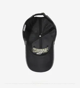 Detail view of cotton baseball cap interior showing embroidery and adjustable metal buckle