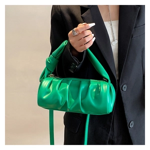 Close-up detail of green ruched cloud bag with a knotted handle and smooth PU leather