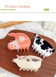 Detailed view of animal shaped acetate hair claws featuring chicken, cow and pig designs