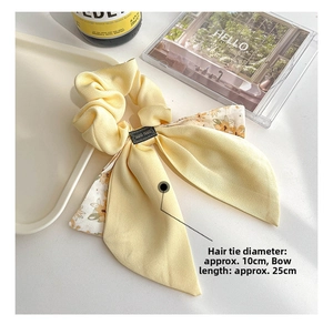 Detail of yellow floral chiffon hair scrunchie with 25cm bow ribbon and handmade label