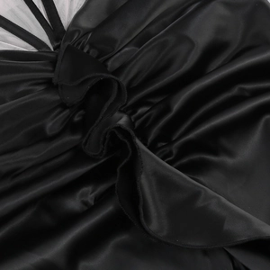 Detail of ruffled black satin fabric with mesh stitching on slim evening dress