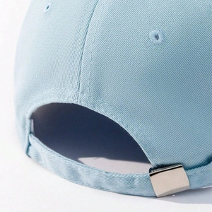 Close-up of light blue cotton baseball cap with adjustable silver metal buckle at back