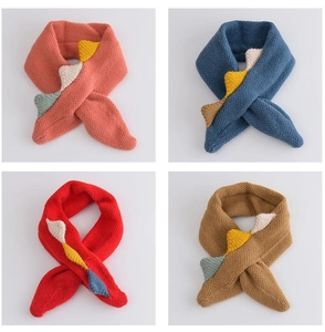 Detail of four colorful dinosaur tail knitted scarves in orange, blue, red and khaki colors