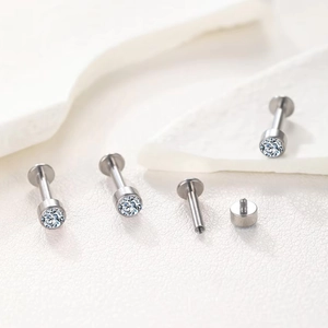 Macro detail of G23 titanium labret studs with internal threading and clear cubic zirconia