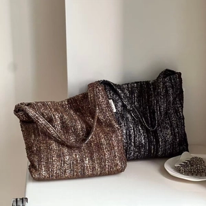 Close-up of retro tweed tote bags in brown and monochrome with textured weave detail