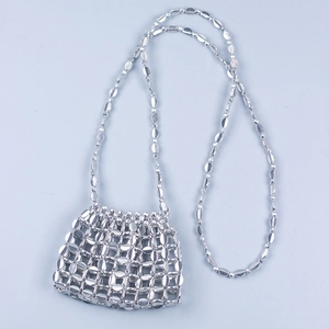 Detail of silver metallic sequin mesh and handmade beadwork on a mini crossbody bag