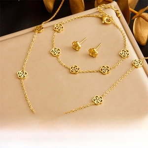 Detailed close-up of gold hollow camellia flower necklace, bracelet and earring set