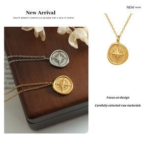 Detailed view of compass pendants in gold and silver finish with fine 18K plating