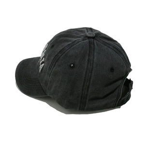Detail view of washed denim baseball cap featuring gray 3D embroidered MAMA letters