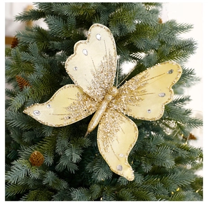 Close-up of golden sequined butterfly ornament with faux diamonds on a Christmas tree
