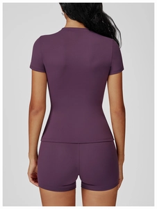 Rear view of moisture-wicking short sleeve yoga top and high-waisted fitness shorts