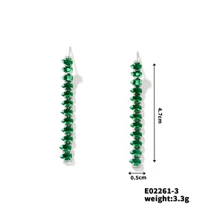 Detailed view showing dimensions of long silver tassel earrings with green pear-cut stones