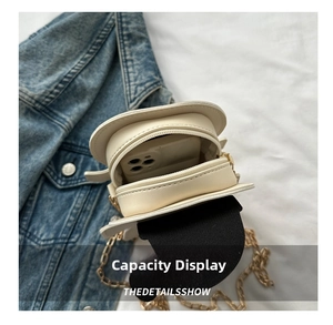 Detailed interior view of a beige mini crossbody bag showing storage capacity for a smartphone