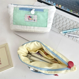Close-up of dual-zipper canvas pencil case with large capacity compartments for stationery