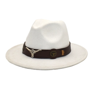 Detail of white wool fedora with brown leather band and silver bull head ornament