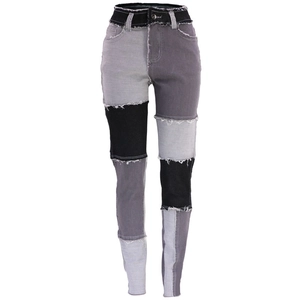Dettaglio dei jeans a vita alta con orlo sfrangiato e design patchwork in denim bicolore