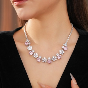 Detail of flower necklace featuring pink circular zircons and white diamond pavé settings