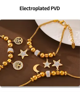 Close-up of gold PVD plated stainless steel bracelet with tree of life and star charms