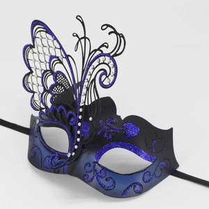 Macro shot of blue gradient masquerade mask with metal butterfly wing and rhinestones