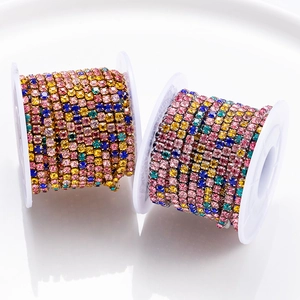 Multi-colored rhinestone claw chains in pink and yellow on gold and silver metal spools
